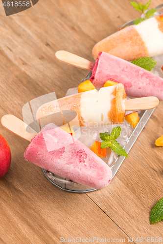 Image of Homemade raspberries and peach popsicles