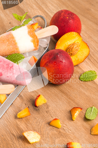 Image of Homemade raspberries and peach popsicles