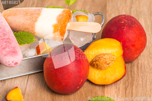 Image of Homemade raspberries and peach popsicles