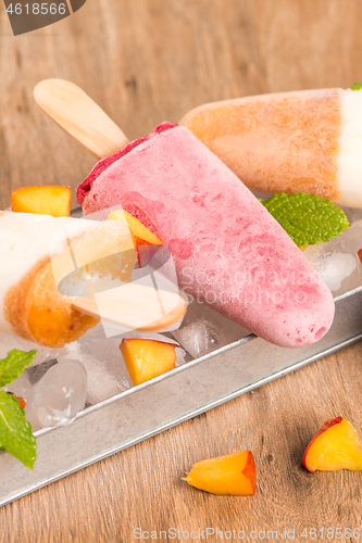 Image of Homemade raspberries and peach popsicles