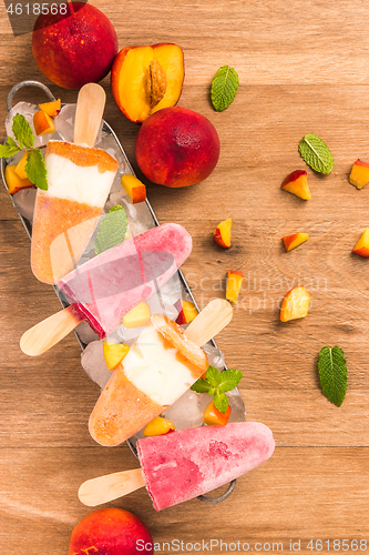 Image of Homemade raspberries and peach popsicles