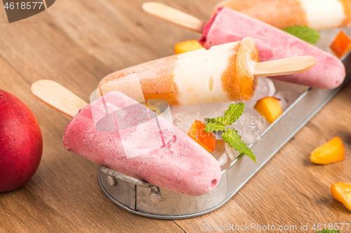 Image of Homemade raspberries and peach popsicles