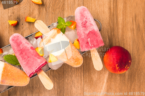 Image of Homemade raspberries and peach popsicles