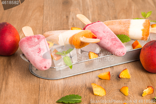 Image of Homemade raspberries and peach popsicles