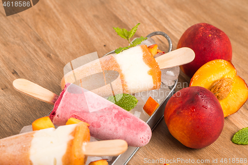 Image of Homemade raspberries and peach popsicles