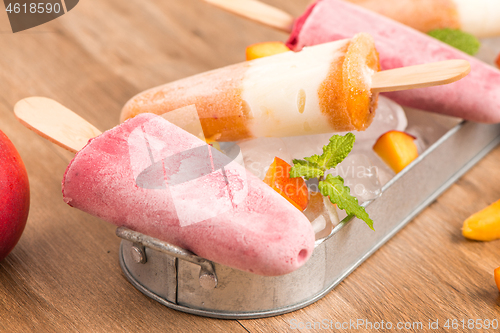 Image of Homemade raspberries and peach popsicles