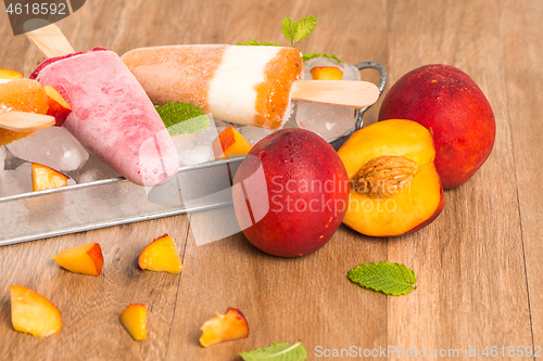 Image of Homemade raspberries and peach popsicles