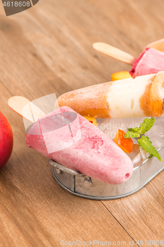 Image of Homemade raspberries and peach popsicles