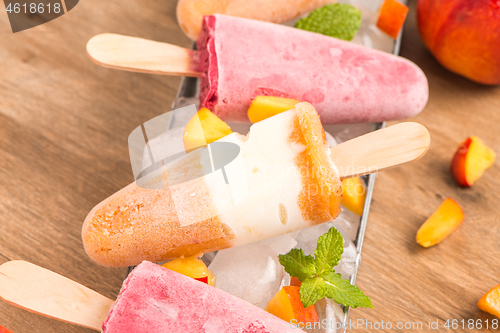 Image of Homemade raspberries and peach popsicles