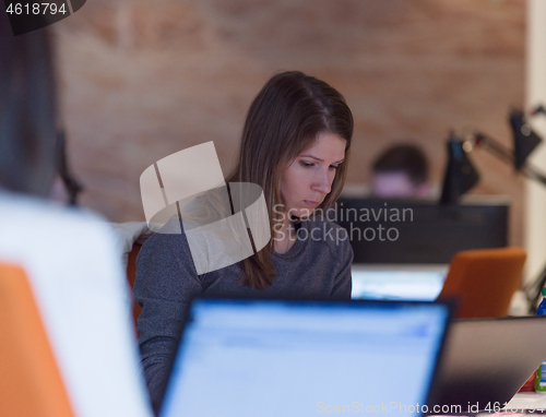 Image of businesswoman using a laptop in startup office