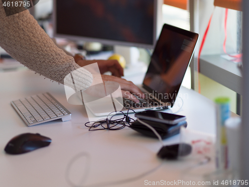 Image of businessman working using a laptop in startup office