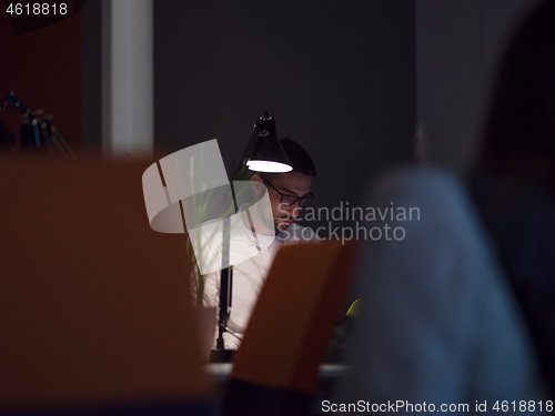 Image of businessman working using a laptop in startup office