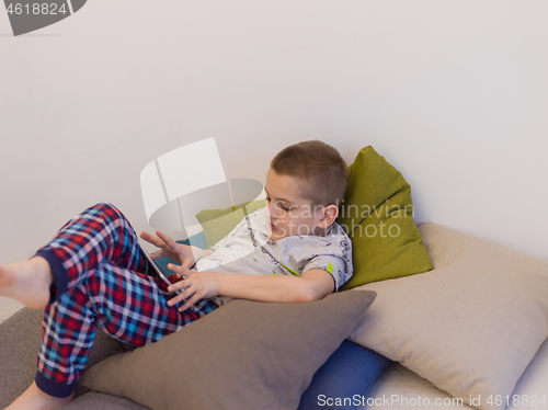 Image of little boy playing games on tablet computers