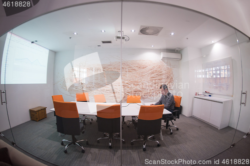 Image of businessman working using a laptop in startup office