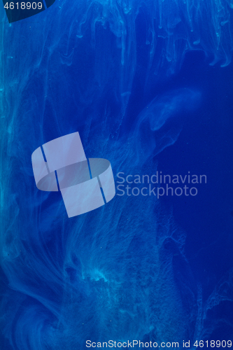 Image of Abstract pattern falling into the water drop of blue ink - cyan ink dissolved in water