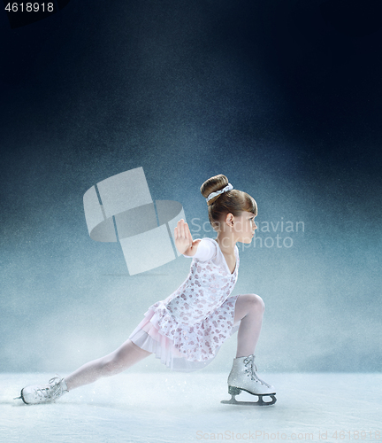 Image of Little girl figure skating at the indoor ice arena.