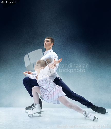 Image of Little girl figure skating at the indoor ice arena.