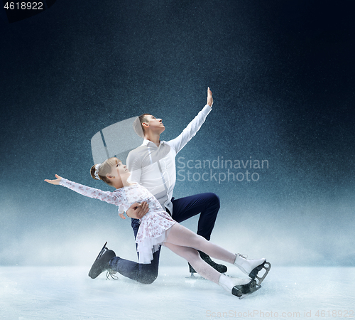 Image of Little girl figure skating at the indoor ice arena.