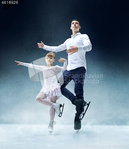 Image of Little girl figure skating at the indoor ice arena.