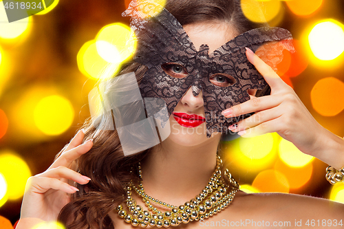 Image of Beauty model woman wearing venetian masquerade carnival mask at party