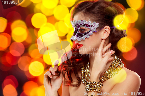 Image of Beauty model woman wearing venetian masquerade carnival mask at party