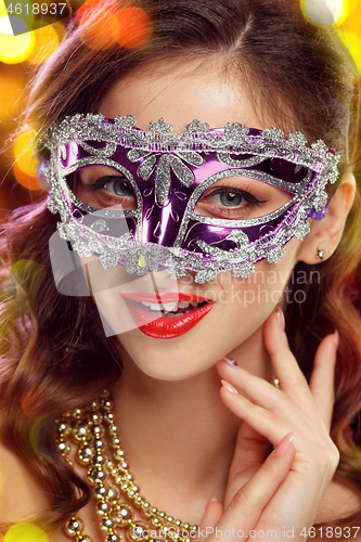 Image of Beauty model woman wearing venetian masquerade carnival mask at party