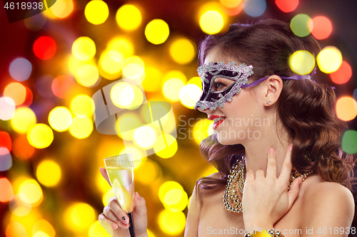 Image of Beauty model woman wearing venetian masquerade carnival mask at party