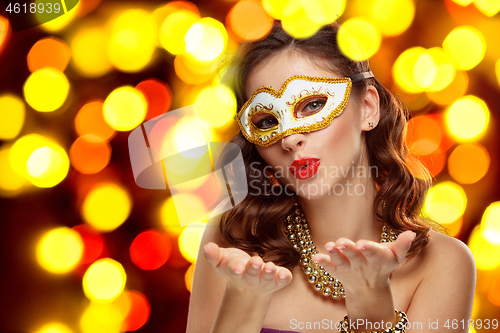 Image of Beauty model woman wearing venetian masquerade carnival mask at party