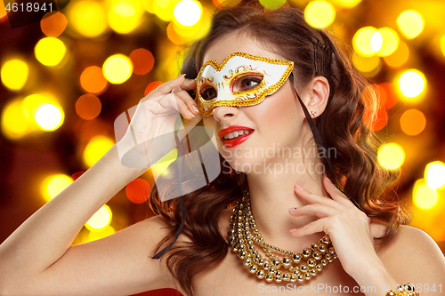 Image of Beauty model woman wearing venetian masquerade carnival mask at party