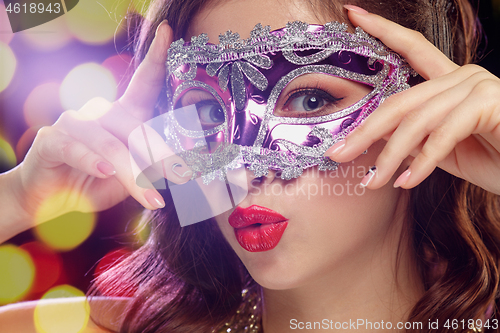 Image of Beauty model woman wearing venetian masquerade carnival mask at party