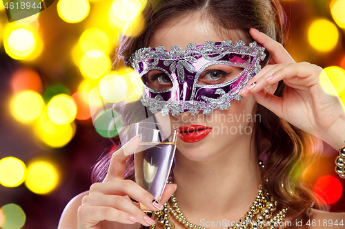 Image of Beauty model woman wearing venetian masquerade carnival mask at party