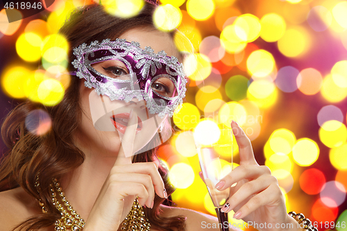 Image of Beauty model woman wearing venetian masquerade carnival mask at party