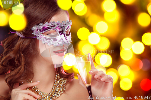 Image of Beauty model woman wearing venetian masquerade carnival mask at party