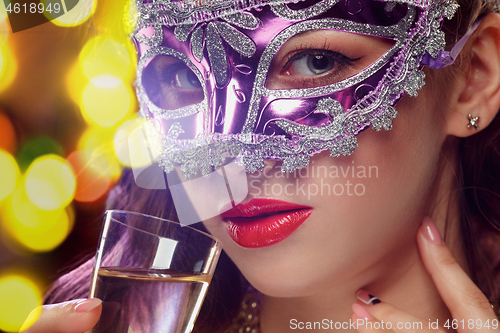 Image of Beauty model woman wearing venetian masquerade carnival mask at party