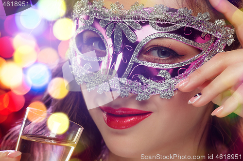 Image of Beauty model woman wearing venetian masquerade carnival mask at party