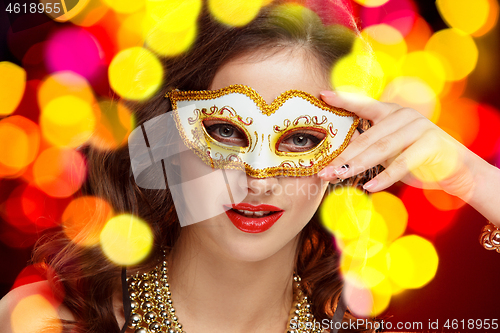 Image of Beauty model woman wearing venetian masquerade carnival mask at party