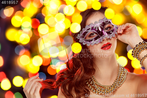 Image of Beauty model woman wearing venetian masquerade carnival mask at party