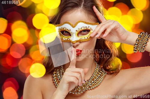 Image of Beauty model woman wearing venetian masquerade carnival mask at party