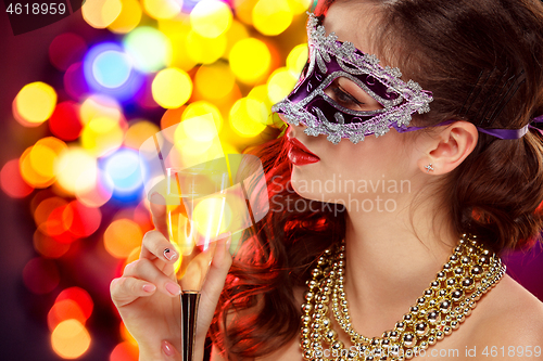 Image of Beauty model woman wearing venetian masquerade carnival mask at party