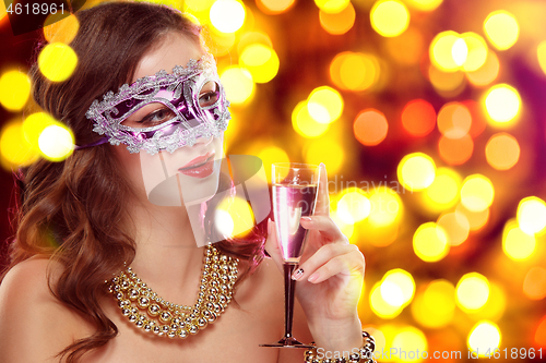 Image of Beauty model woman wearing venetian masquerade carnival mask at party