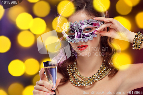 Image of Beauty model woman wearing venetian masquerade carnival mask at party