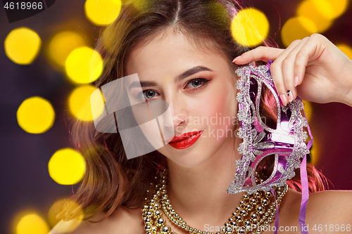 Image of Beauty model woman wearing venetian masquerade carnival mask at party