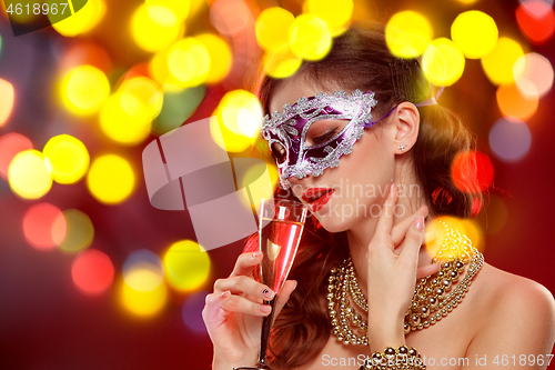 Image of Beauty model woman wearing venetian masquerade carnival mask at party