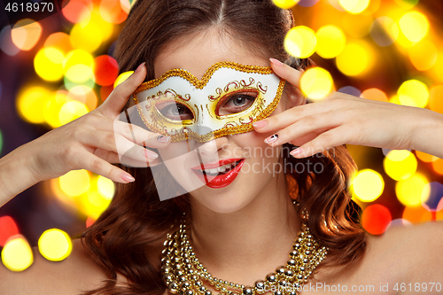 Image of Beauty model woman wearing venetian masquerade carnival mask at party