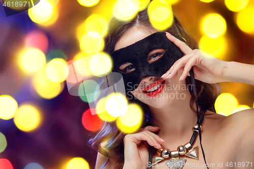 Image of Beauty model woman wearing venetian masquerade carnival mask at party