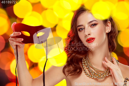 Image of Beauty model woman wearing venetian masquerade carnival mask at party