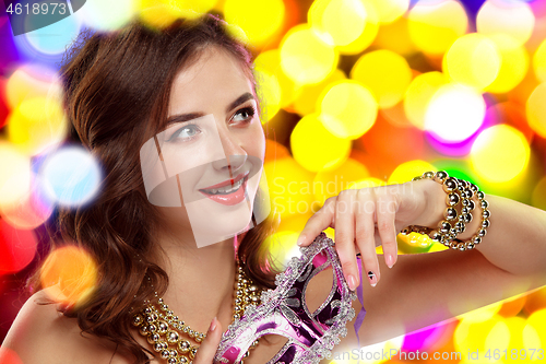 Image of Beauty model woman wearing venetian masquerade carnival mask at party