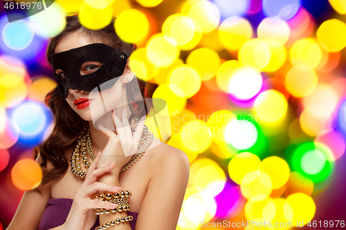 Image of Beauty model woman wearing venetian masquerade carnival mask at party