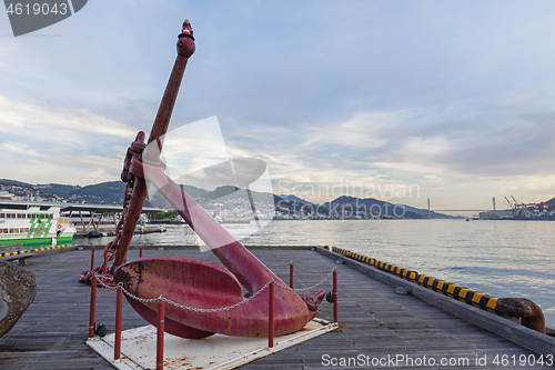 Image of Big old red anchor on the pier