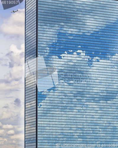 Image of Clouds reflected in windows of modern office building